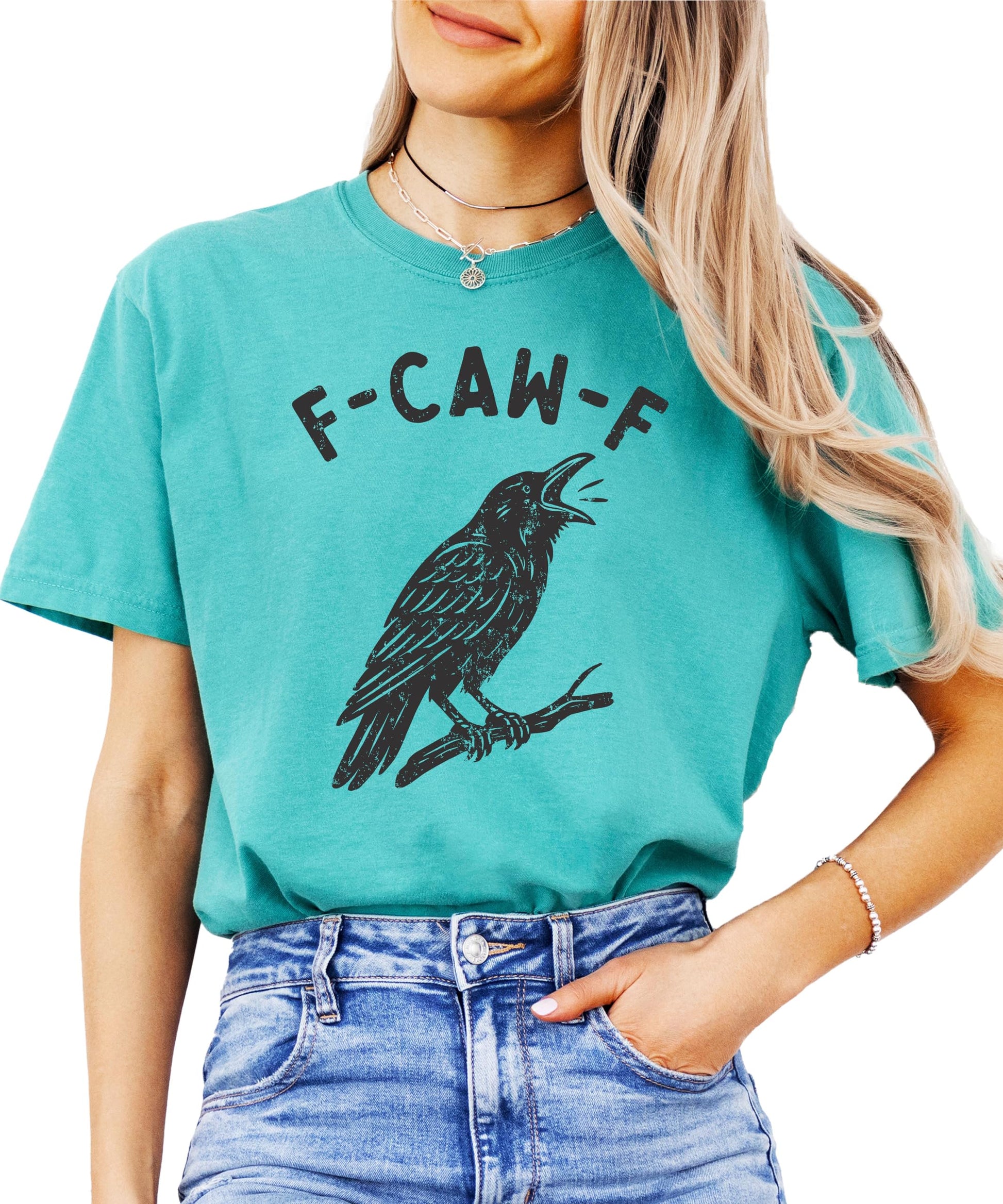 Side view of funny crow Halloween shirt in seafoam green showcasing relaxed fit on adult