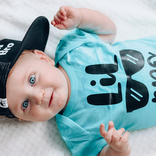 Little Bro Glasses bodysuit displayed as a baby shower gift idea