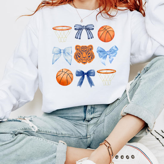 Close-up of Tigers mascot coquette bows basketball graphic on white sweatshirt