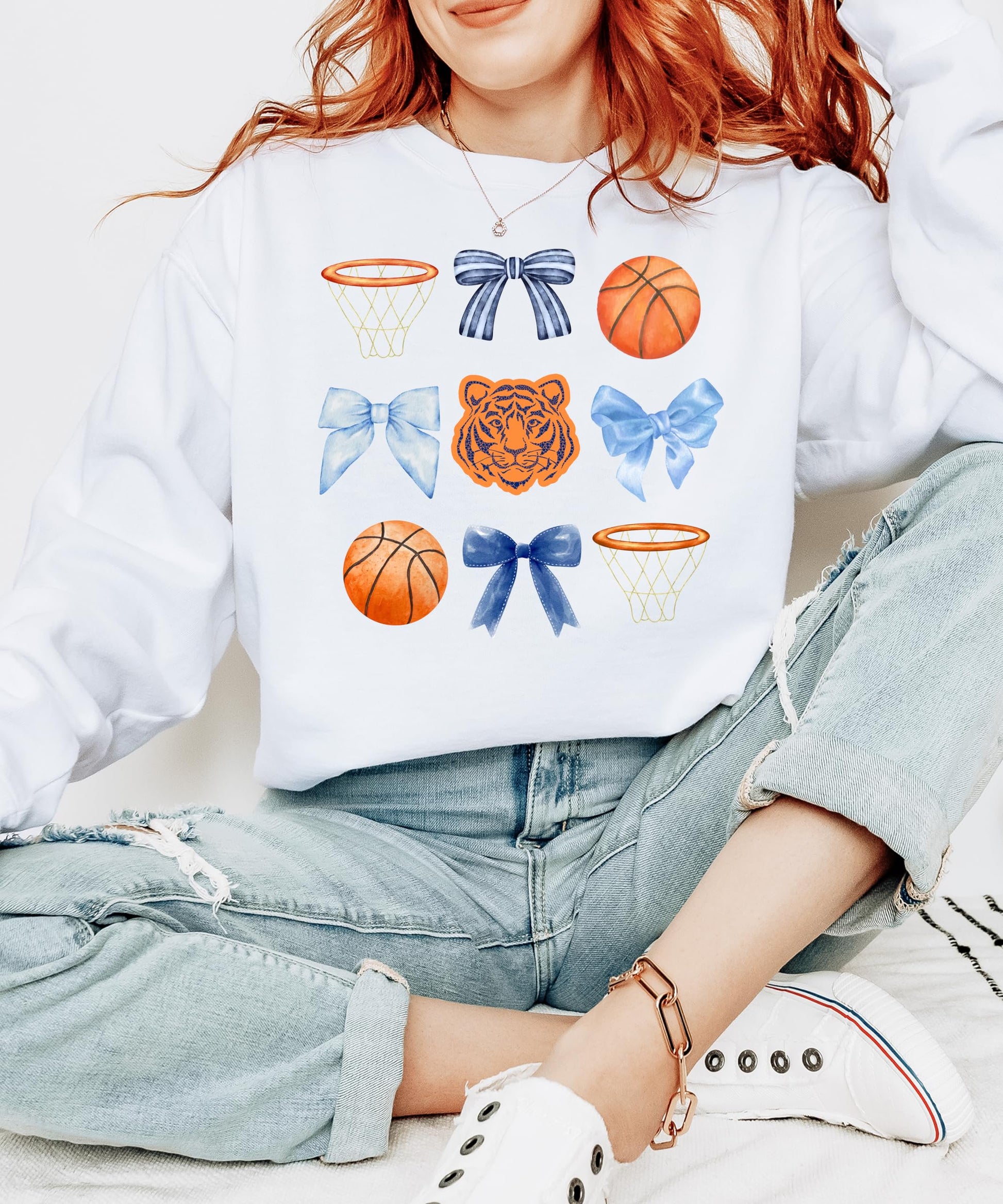 Close-up of Tigers mascot coquette bows basketball graphic on white sweatshirt
