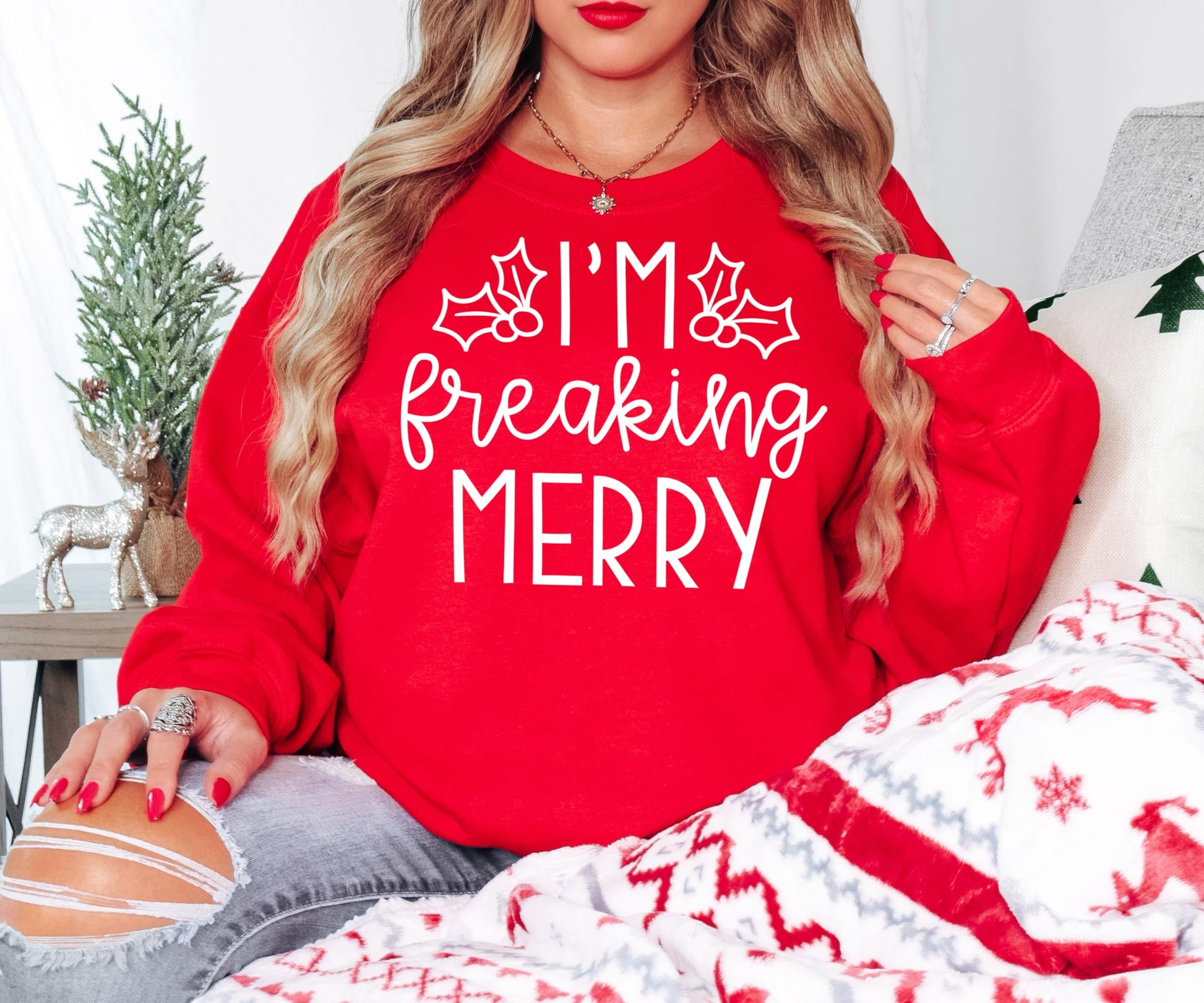 Front view of funny red women's crewneck sweatshirt with bold holiday graphic design