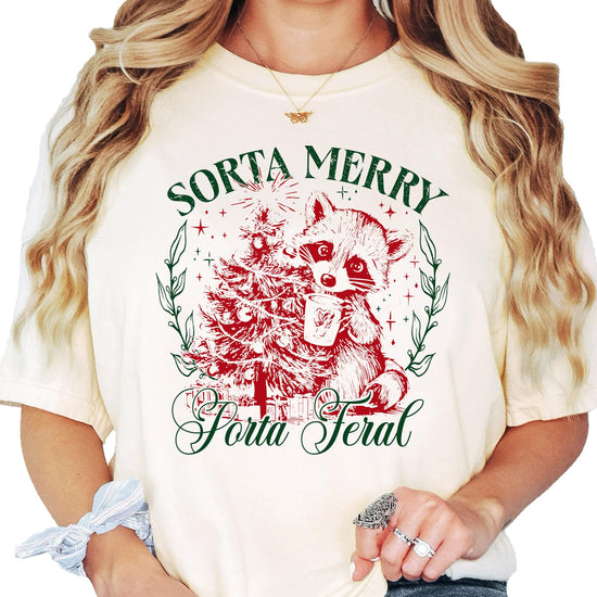 Back or lifestyle view of funny Christmas raccoon tee for women in ivory by Olive Loves Apple