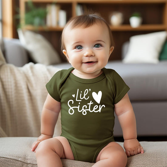 Mauve newborn bodysuit with white heart and Lil Sister text graphic