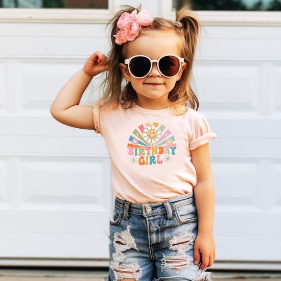 Front view of kids birthday girl graphic tee with sunbeam and flower design