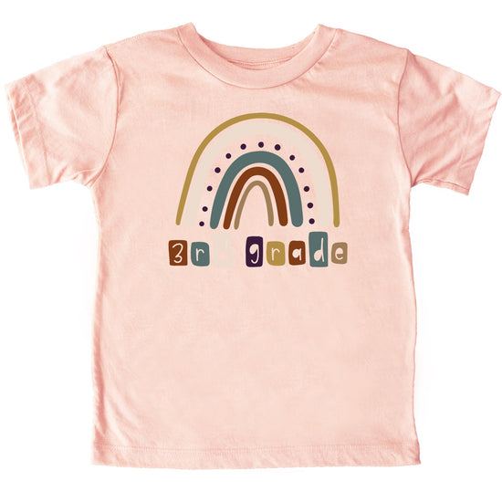 Close-up of vibrant rainbow graphic on kids first day of school tee