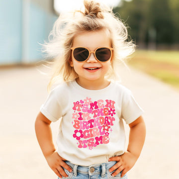 Front view of groovy floral birthday girl tee in peach for toddler and youth