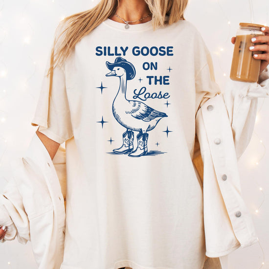 Flat lay of Silly Goose on the Loose ivory graphic tee for women