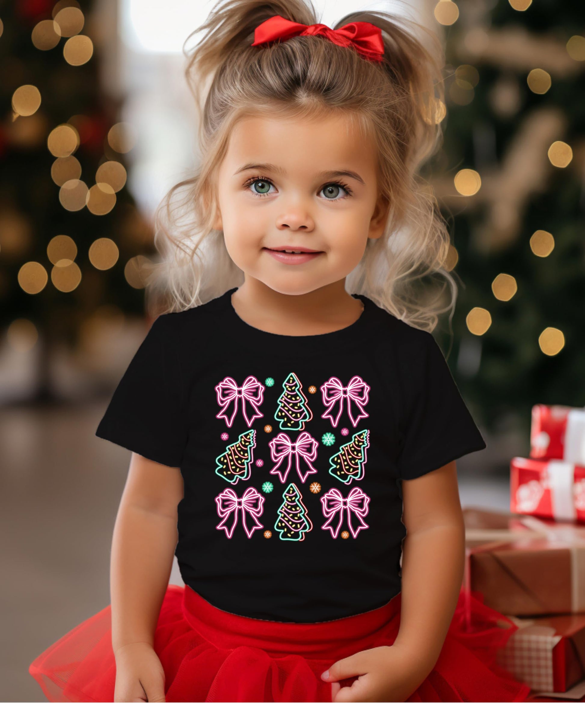 Flat lay of black women's holiday tee showcasing electric neon Christmas trees and gift bows print