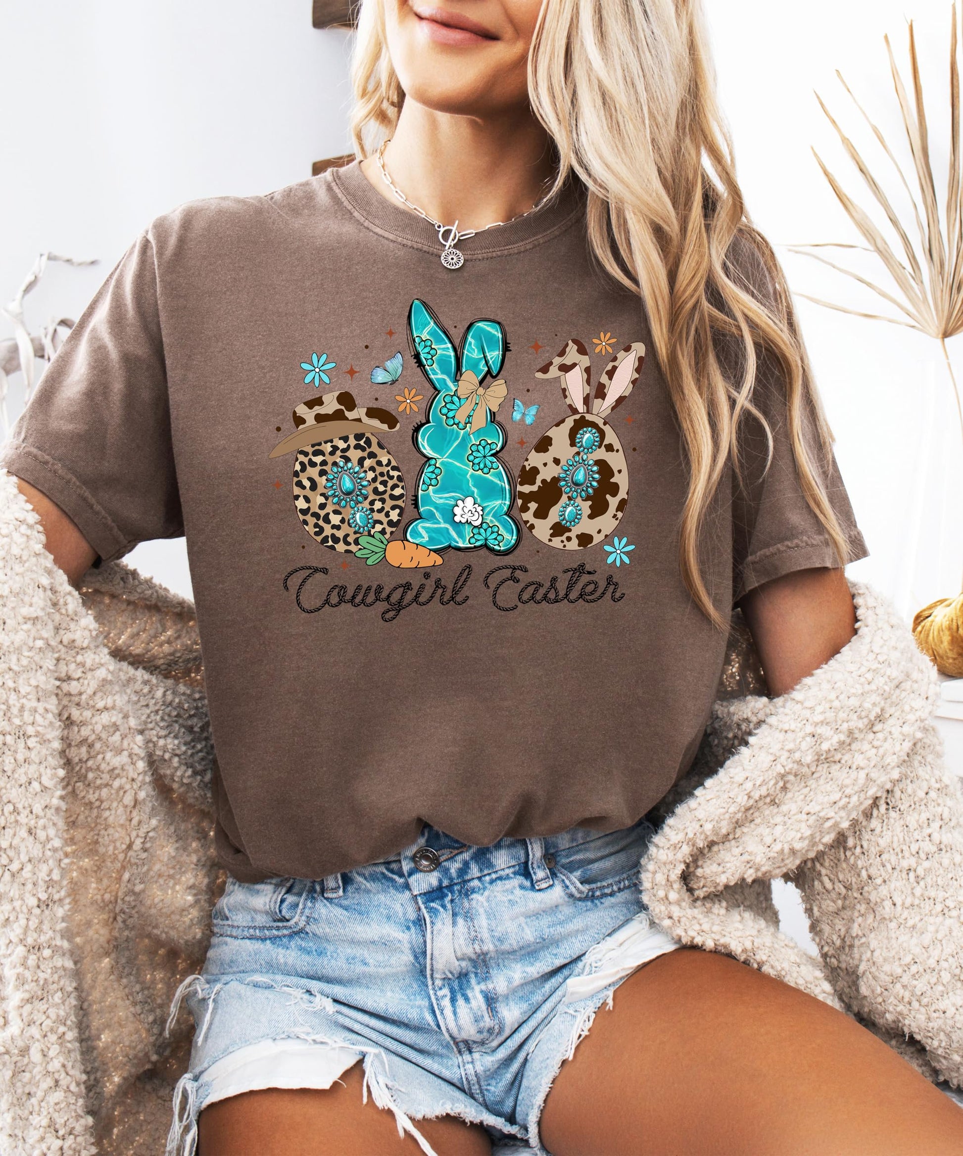 Close-up of cowgirl Easter graphic tee showing rope-style lettering and cow print hat bunny illustration