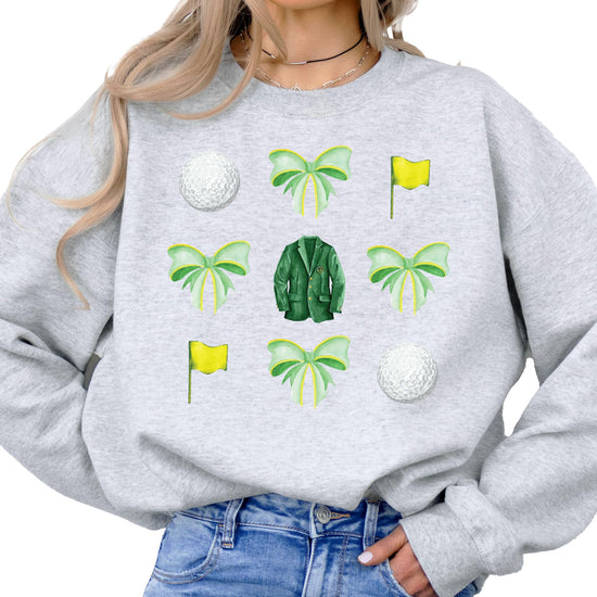 Front view of golf tournament sweatshirt with colorful bows and golf ball print on white
