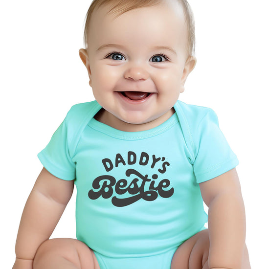 Flat lay of Daddy's Bestie baby bodysuit showing snap closure and full graphic design
