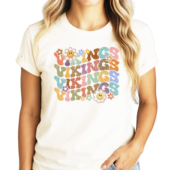Close-up of Vikings team pride shirt showing colorful retro lettering with flowers and happy faces