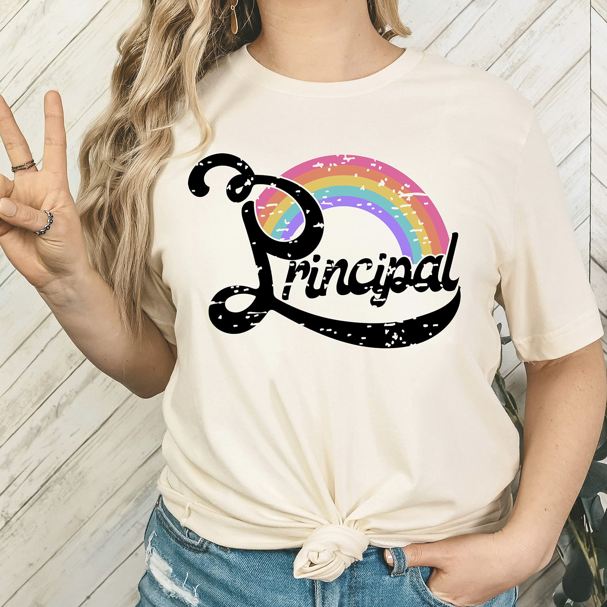 Women's principal appreciation tee with rainbow design, shown flat lay on black shirt