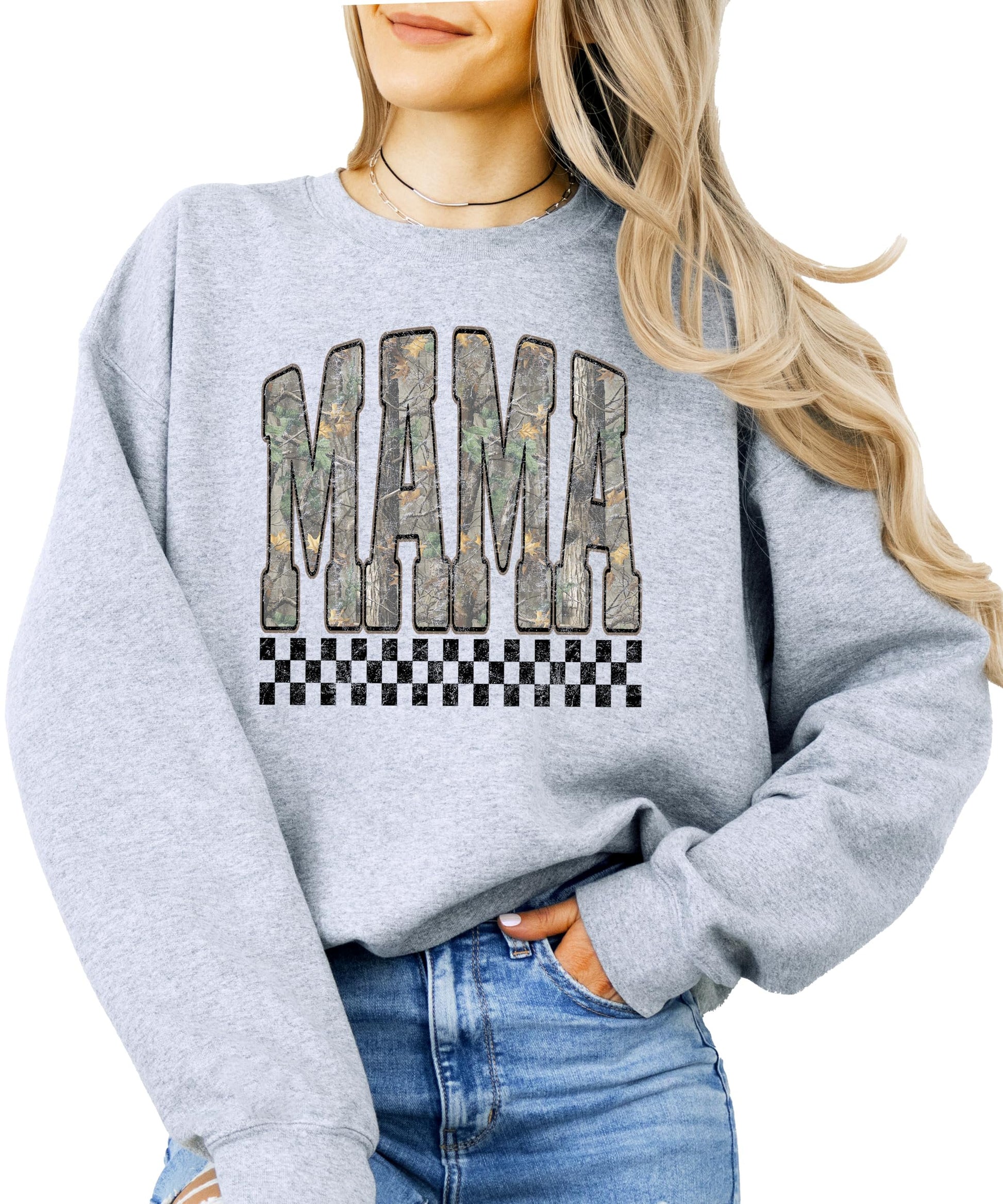 Close-up of bold MAMA lettering in distressed camouflage print on black crewneck sweatshirt