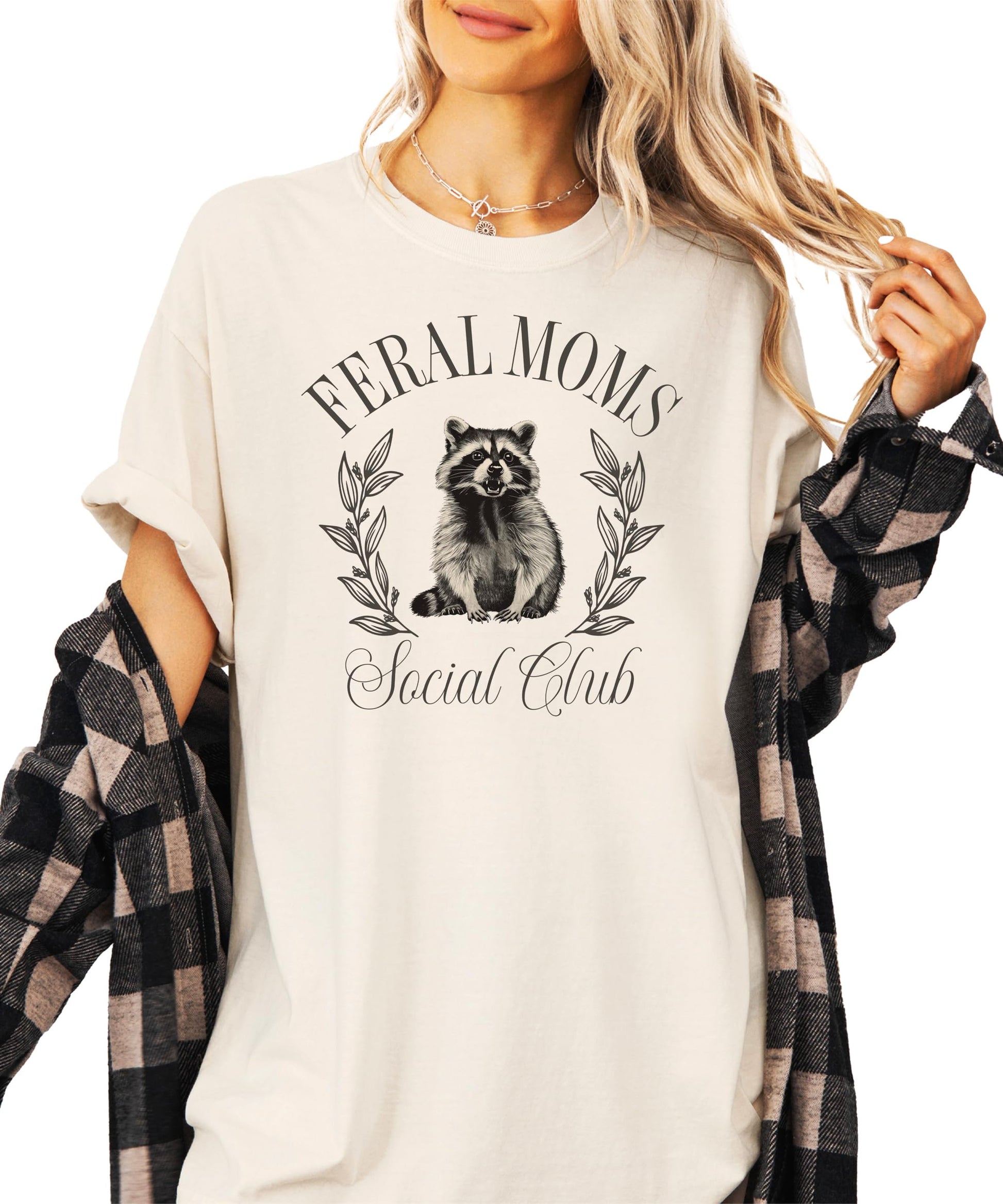 Feral Moms Social Club ivory women's tee with mischievous raccoon graphic and bold text
