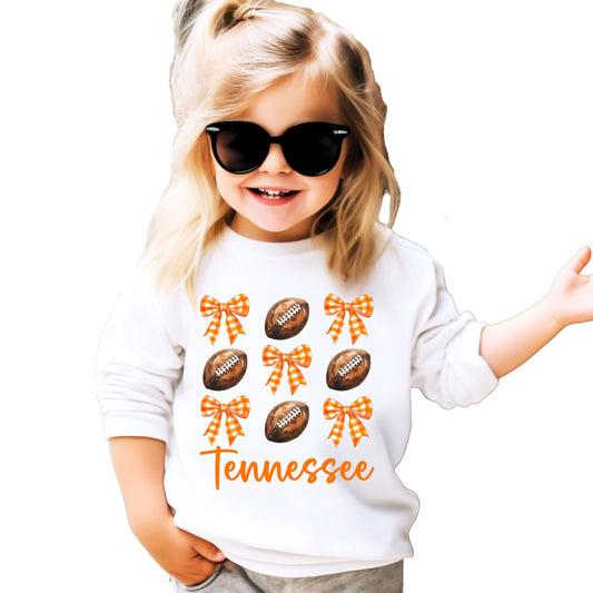 Close-up of Tennessee football sweatshirt design showing orange bow and football details