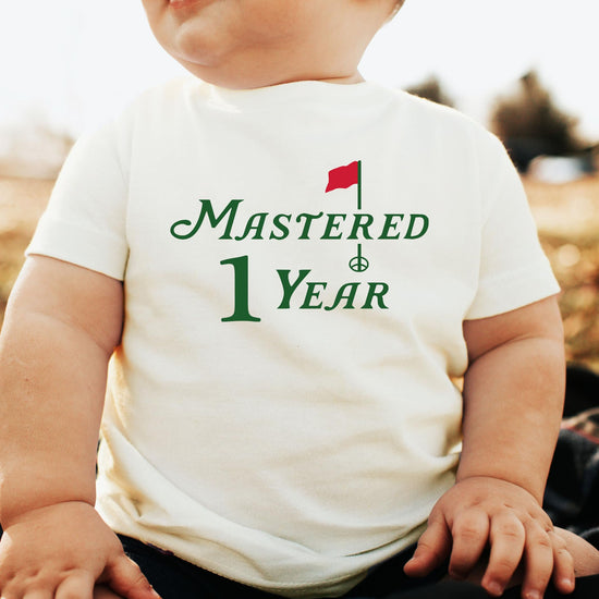 Close-up of Mastered 1 Year golf birthday shirt print on natural fabric