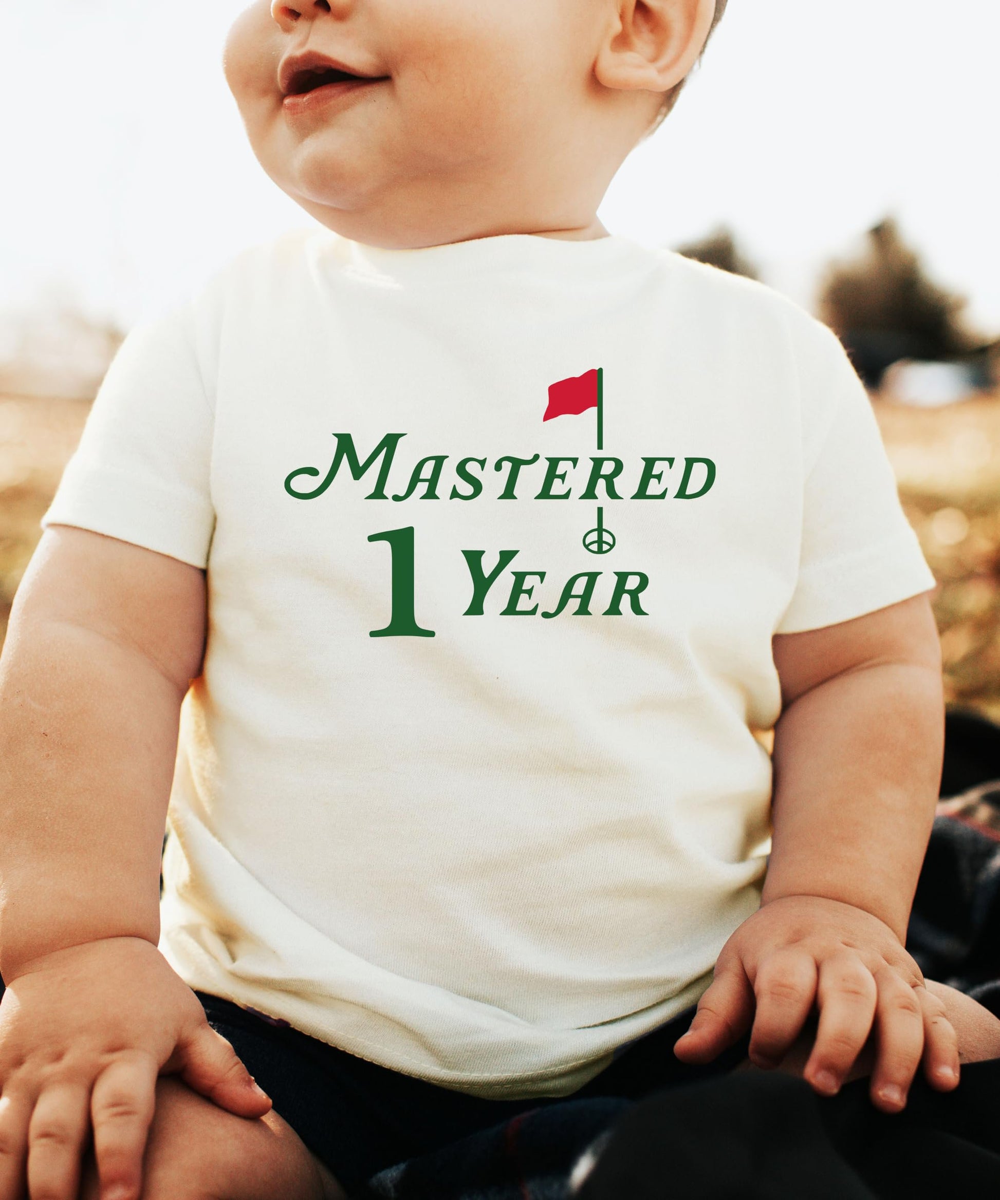 Close-up of Mastered 1 Year golf birthday shirt print on natural fabric