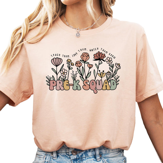 Front view of floral Pre-K Squad graphic tee in peach for women teachers