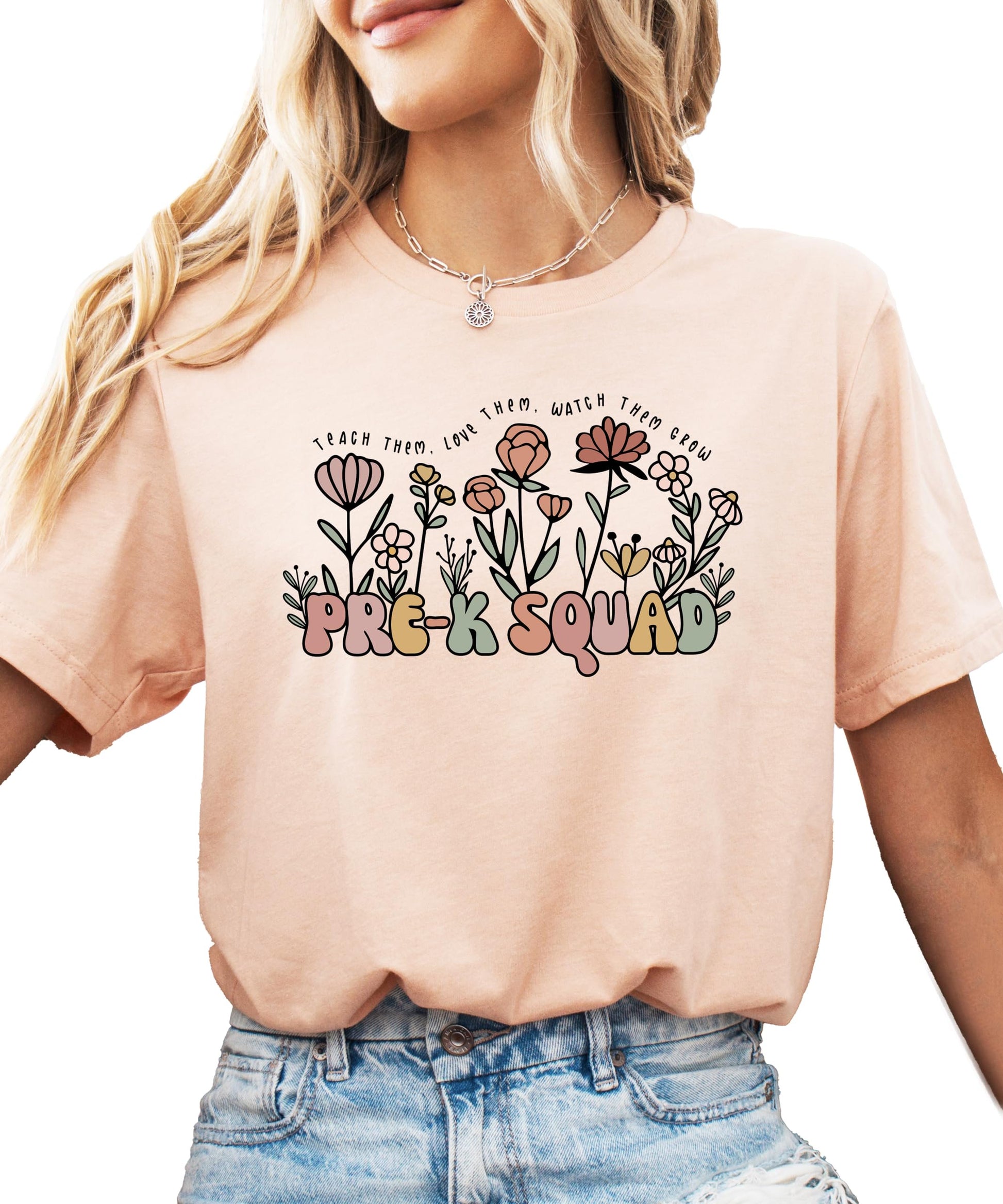Front view of floral Pre-K Squad graphic tee in peach for women teachers