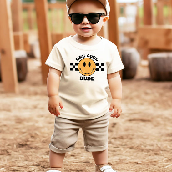 Detail shot of One Cool Mom 1st birthday shirt print on natural fabric