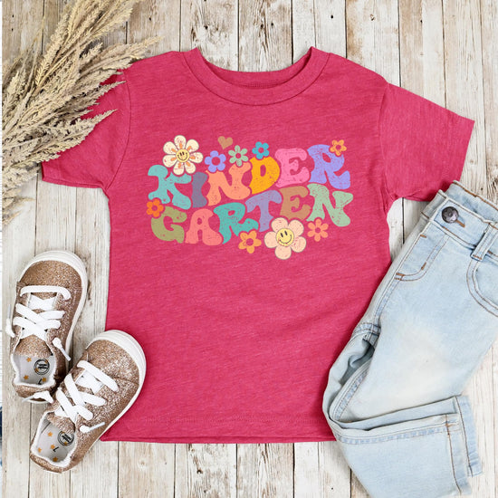 Kindergarten first day of school groovy daisy youth tee displayed on flat surface, full view