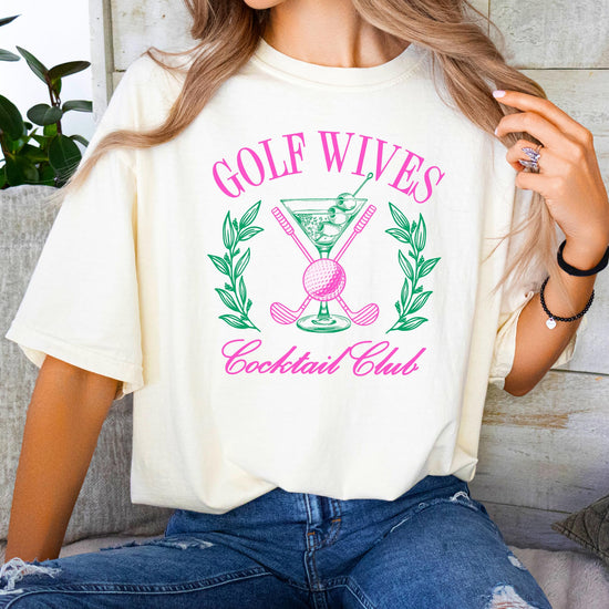 Close-up of Golf Wives Cocktail Club shirt design showing dirty martini glass and crossed golf clubs print detail