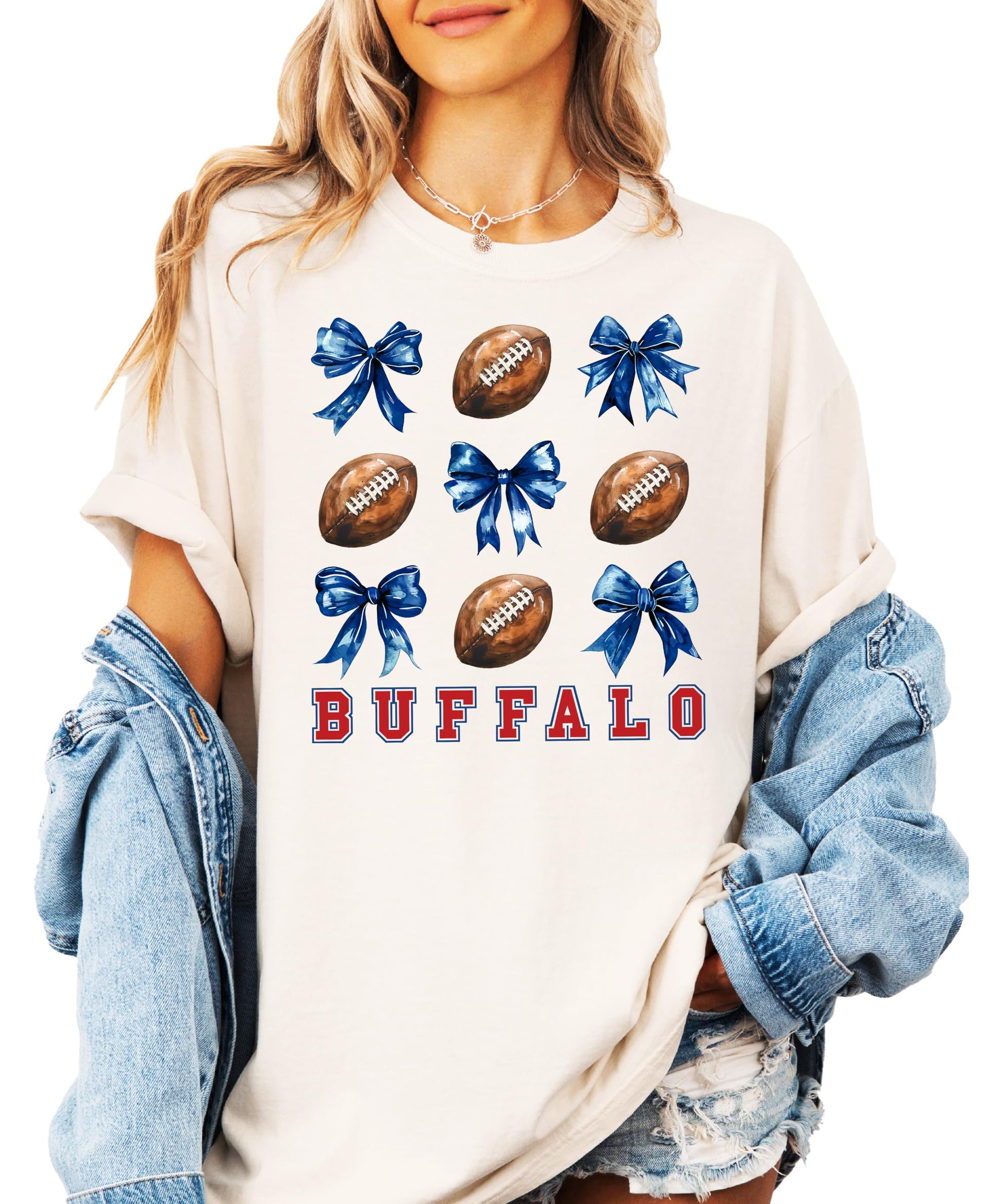 Close-up of Buffalo football shirt print showing red lettering, footballs, and blue coquette bow details