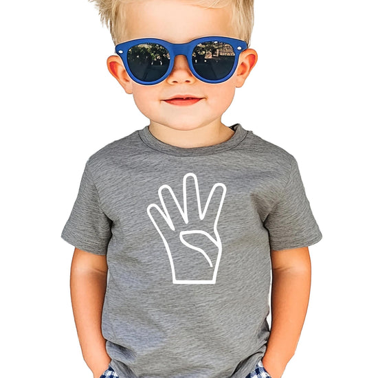 Front view of kids 4th birthday shirt with fun graphic print on black tee