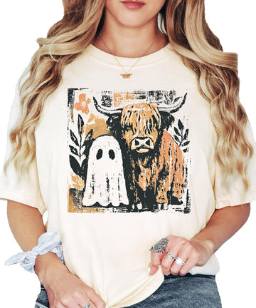 Women's ivory graphic tee featuring a cute ghost and highland cow Halloween design for fall