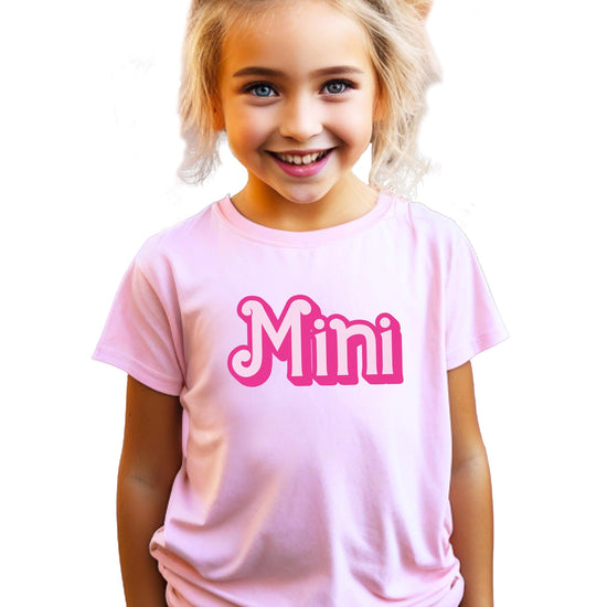 Close-up of bubbly font print on pink Mama and Mini matching shirt
