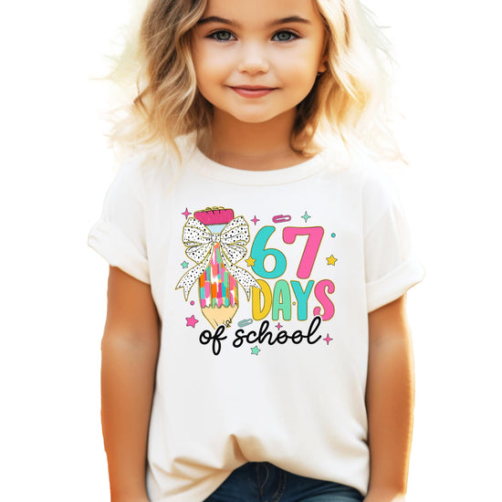 Front view of funny 67 Days of School girls' t-shirt with colorful pencil and coquette bow graphic
