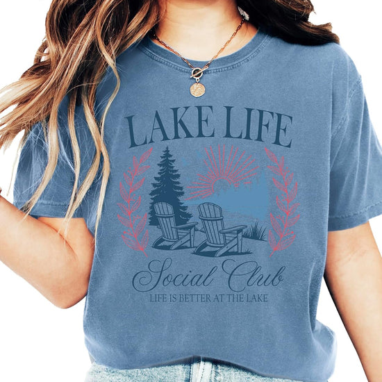 Close-up detail of Lake Life Social Club vintage-style lake house design print on ivory shirt