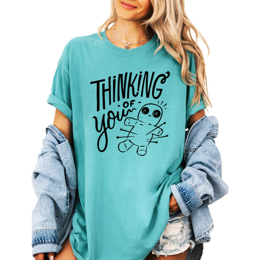 Black voodoo doll shirt with Thinking of You text and pin graphic for women