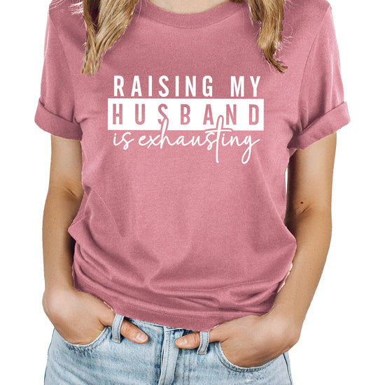 Heather blue women's graphic tee with 'Raising My Husband Is Exhausting' funny wife design