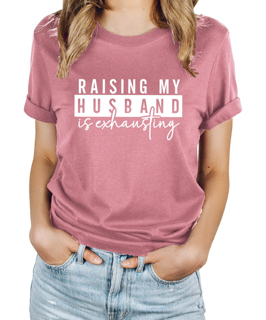 Heather blue women's graphic tee with 'Raising My Husband Is Exhausting' funny wife design