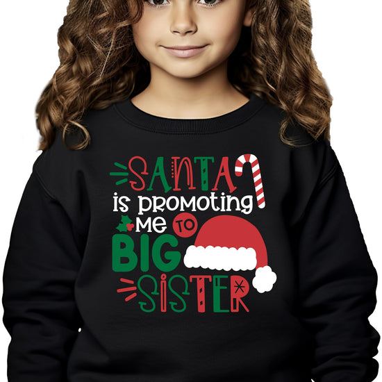 Detail shot of soft heather sweatshirt fabric with bold 'Promoted to Big Sister' Christmas graphic