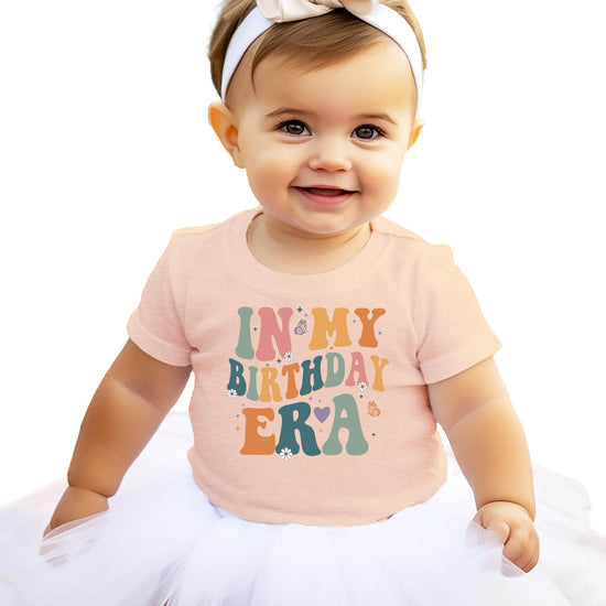 Kids 'In My Birthday Era' peach graphic tee with trendy wavy lettering design for girls