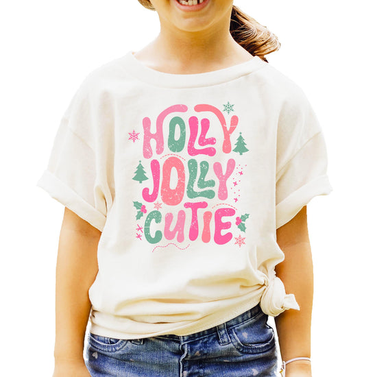 Front view of pink festive Christmas shirt for girls with colorful holiday graphic design