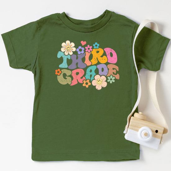 Close-up of vibrant groovy daisy graphic on kids first day of school tee