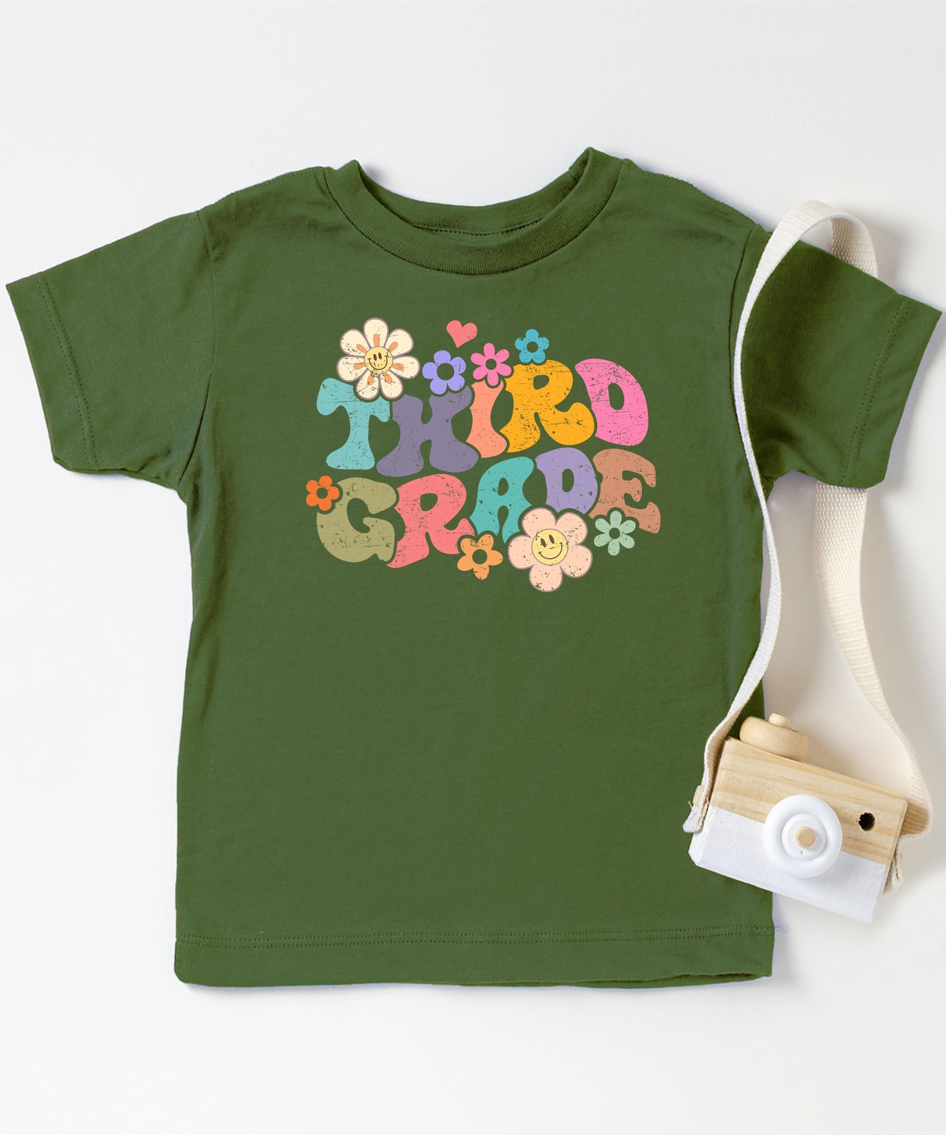 Close-up of vibrant groovy daisy graphic on kids first day of school tee