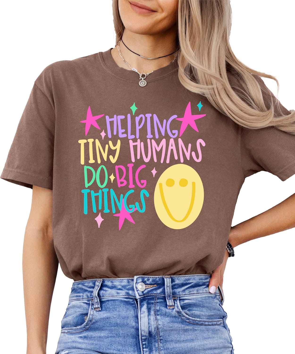 Woman wearing Helping Tiny Humans Do Big Things teacher tee showing relaxed unisex fit on garment-dyed Comfort Colors shirt