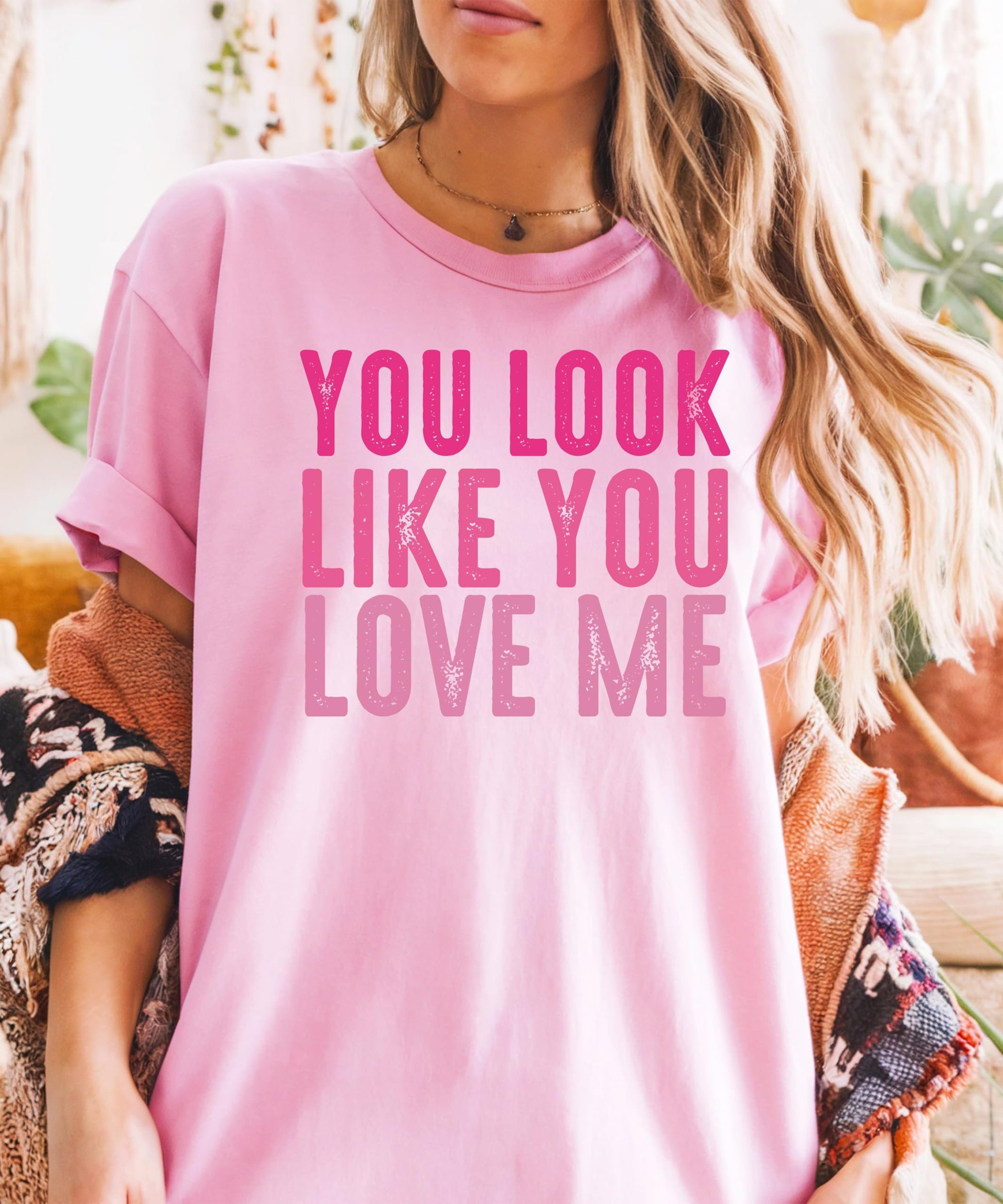 Side angle of black women's tee featuring You Look Like You Love Me pink text