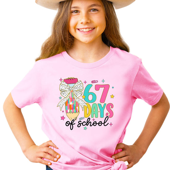 Close-up of coquette bow pencil meme print on kids' school milestone graphic tee