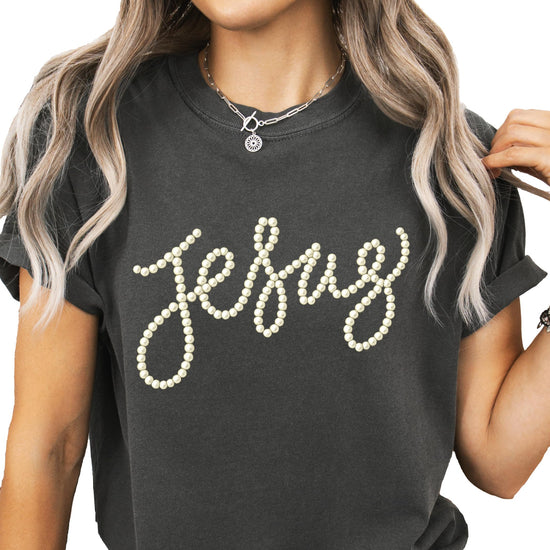Flat lay or folded view of seafoam pearl script Jesus women's graphic tee