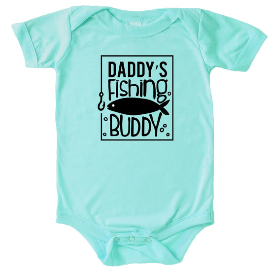 Flat lay of Daddy's Fishing Buddy baby bodysuit in peach with little fisherman graphic