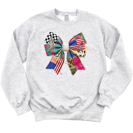 Women's white patriotic sweatshirt with raw-edge bow graphic, styled for Fourth of July casual wear