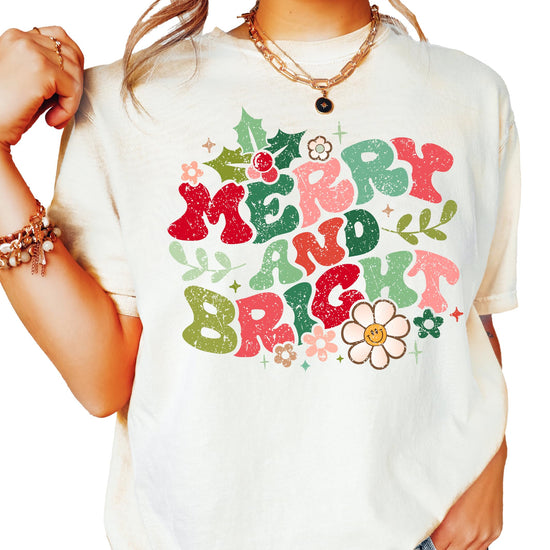 Distressed Merry and Bright ivory graphic Christmas tee for women with floral holiday accents