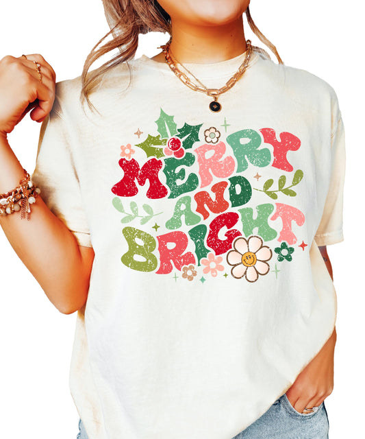 Distressed Merry and Bright ivory graphic Christmas tee for women with floral holiday accents