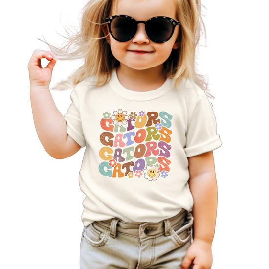 Gators groovy retro graphic tee with smiley flowers and colorful lettering on a natural shirt
